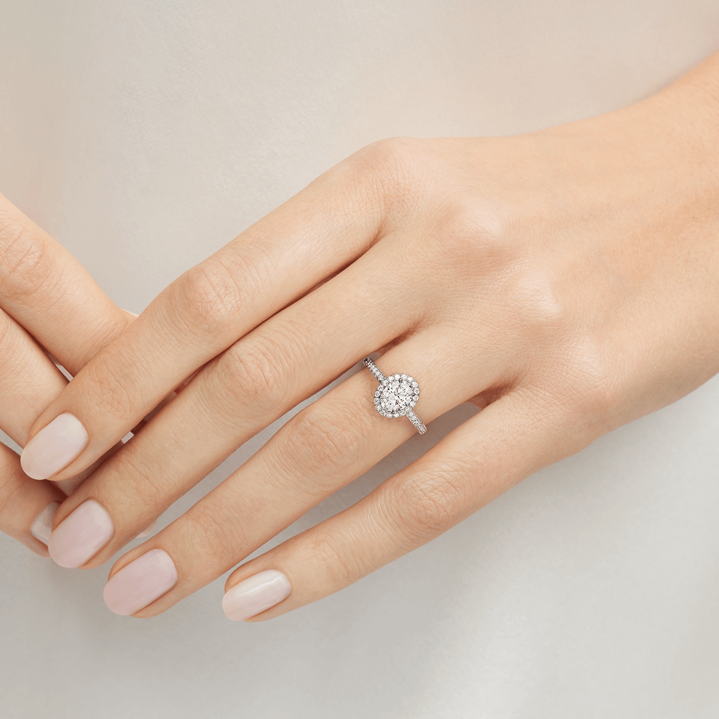 The One Oval-Shaped Diamond Micropavé Engagement Ring featured on a model